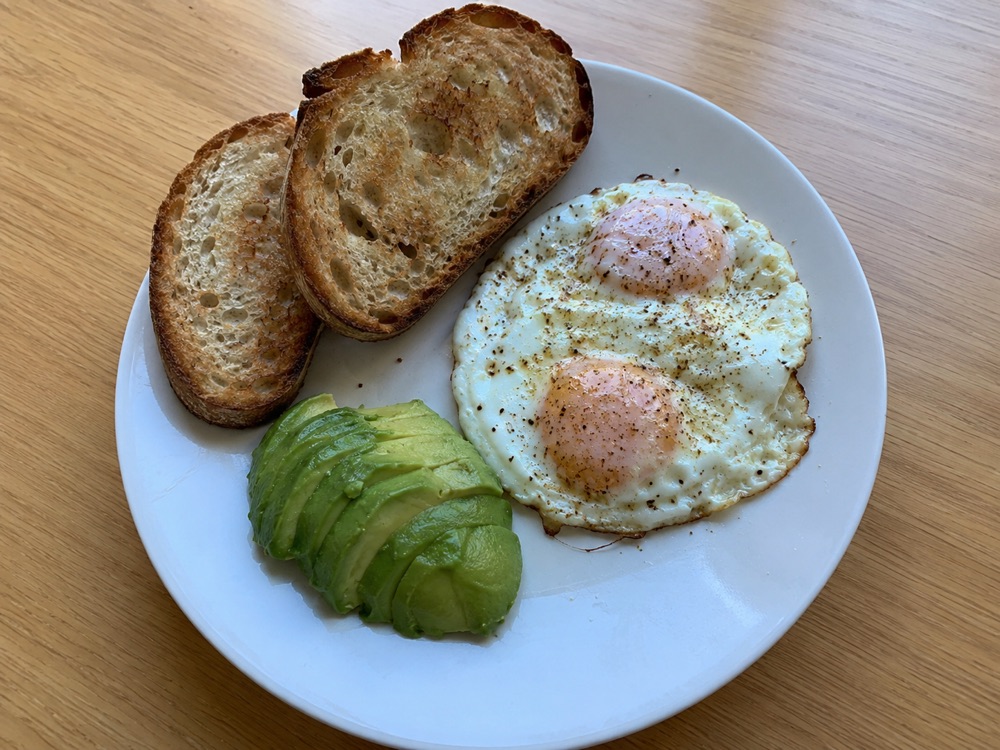 a photo of lunch — eggs, sourdough toast, and avocado